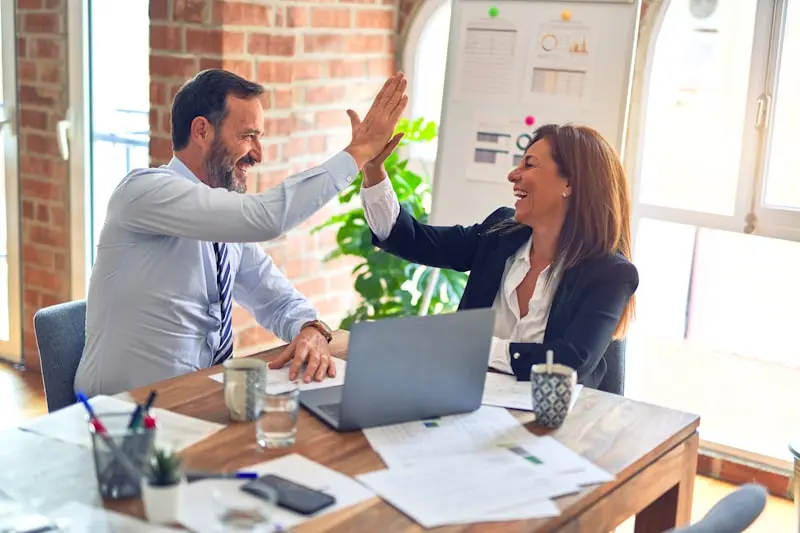 Small business owner reviewing a full-funnel digital marketing growth plan with one strategist